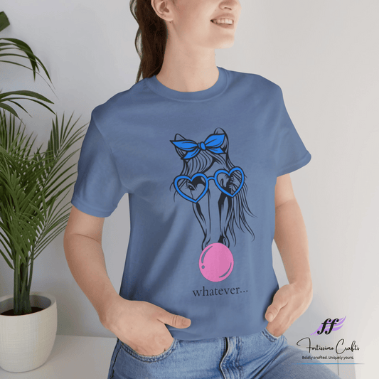 Person wearing a blue t-shirt with a graphic design and text, standing indoors next to a plant.