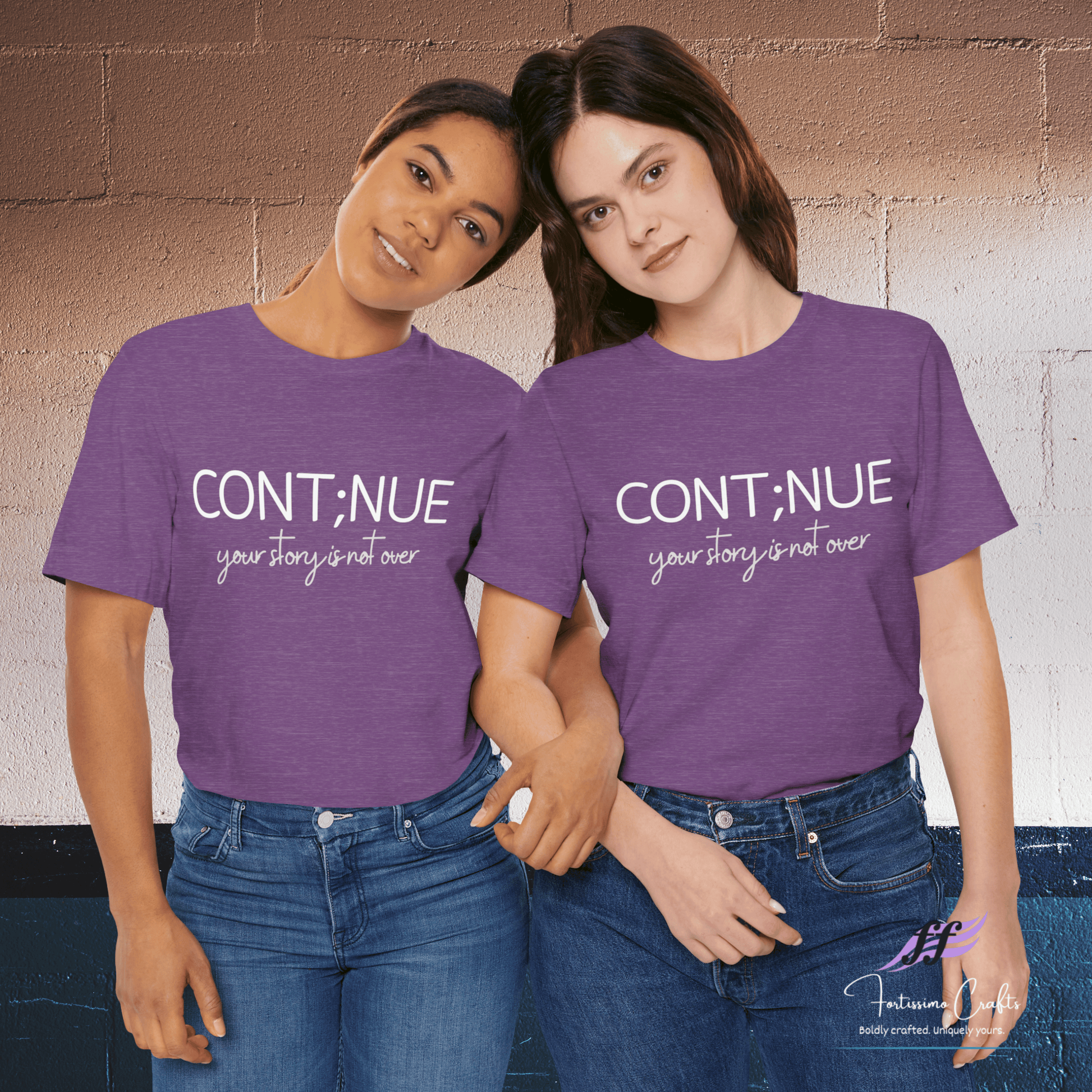 Two people wearing purple shirts with 'CONT;NUE your story is not over' text against a brick wall.