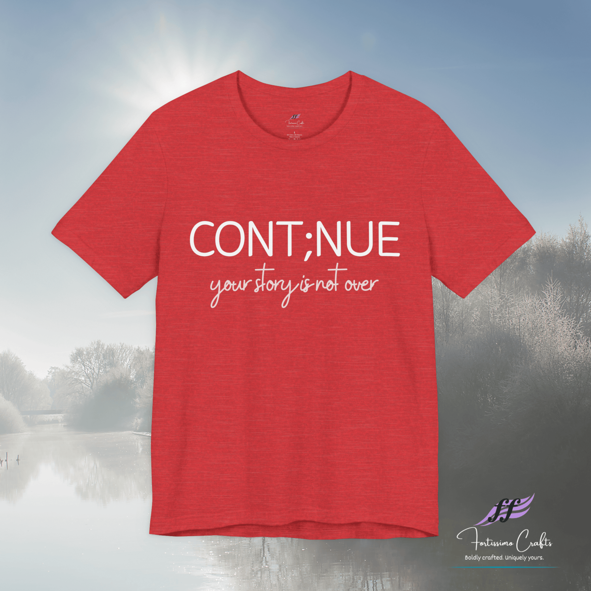 Red t-shirt with 'CONT;NUE your story is not over' text on a blurred outdoor background
