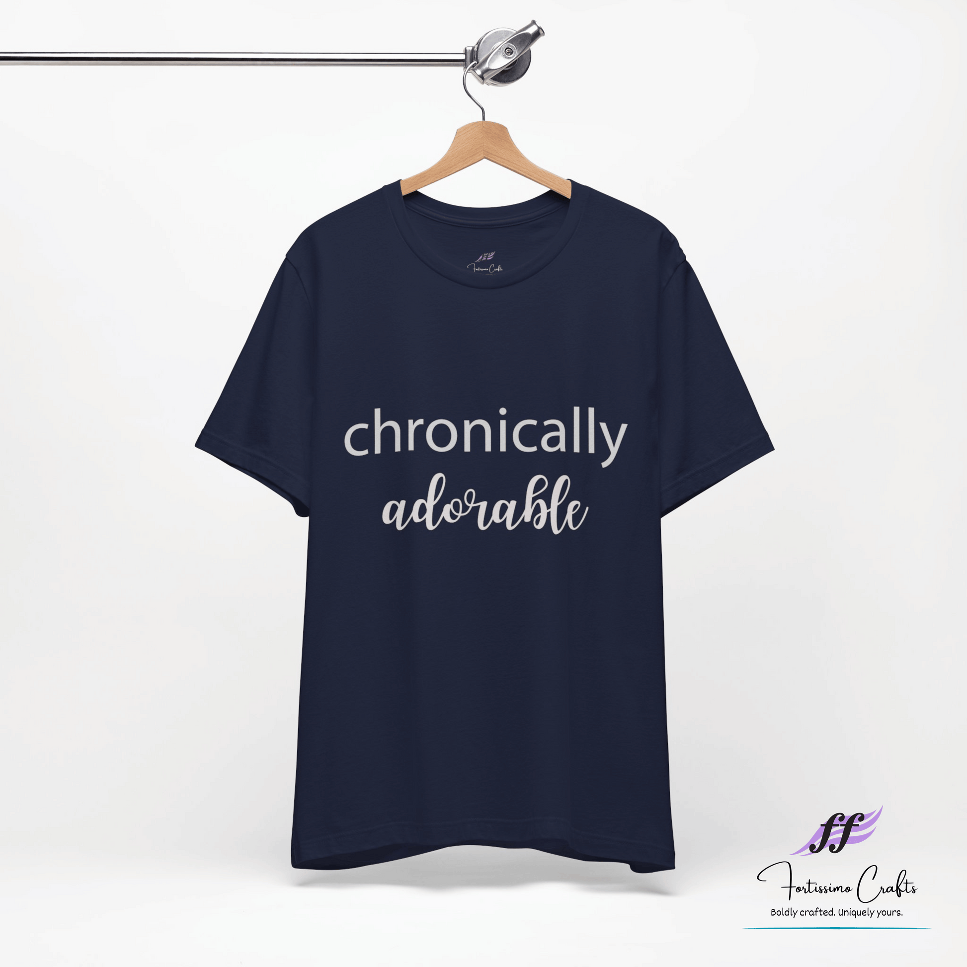 Navy blue t-shirt with 'chronically adorable' text on a hanger against a white background