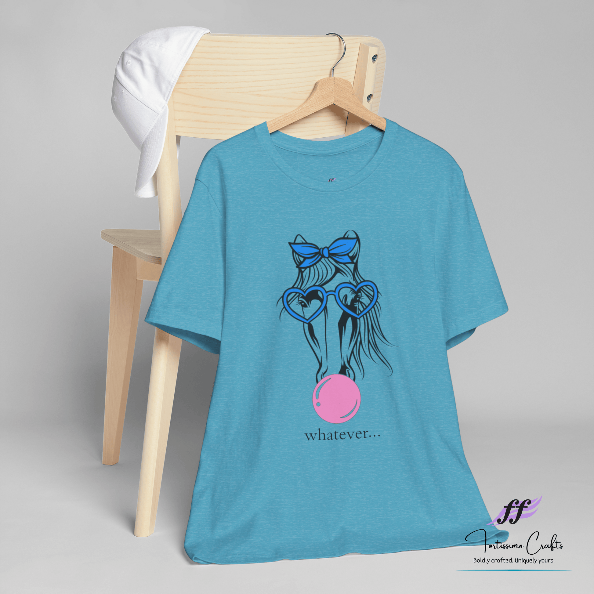 Blue t-shirt with a graphic design and text on a chair against a gray background