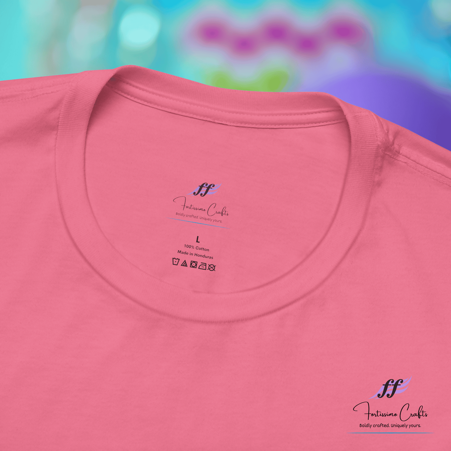 Close-up of a pink t-shirt with a brand label on a colorful blurred background