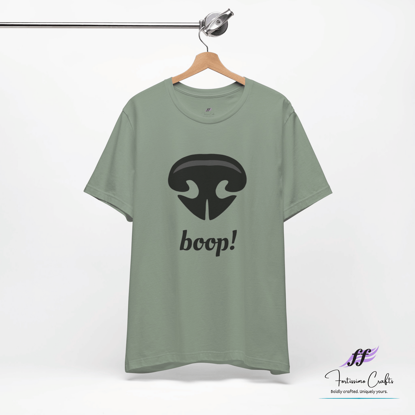 Green t-shirt with a black dog nose and 'boop!' text on a hanger against a white background.