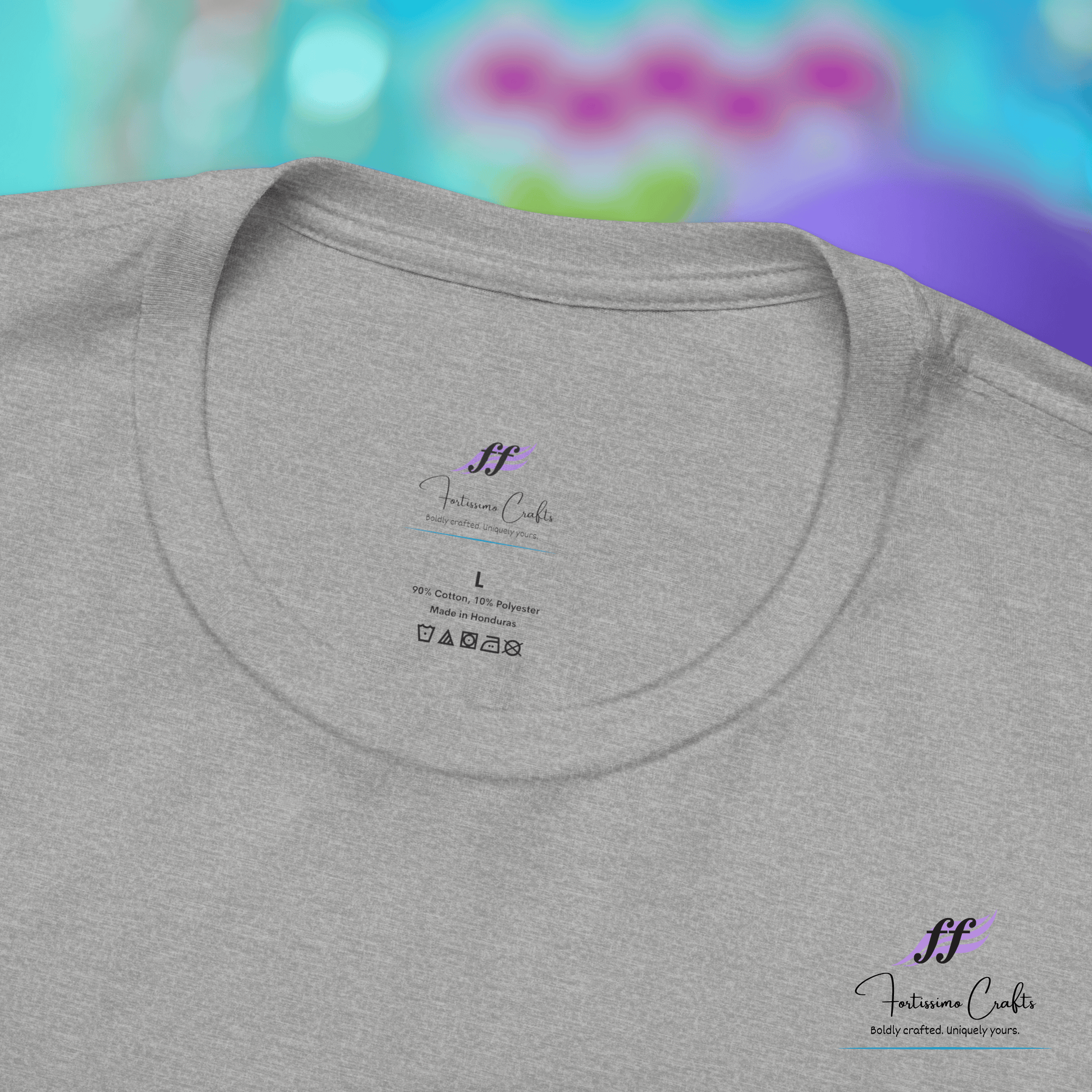 Gray t-shirt with a brand logo on a blurred colorful background