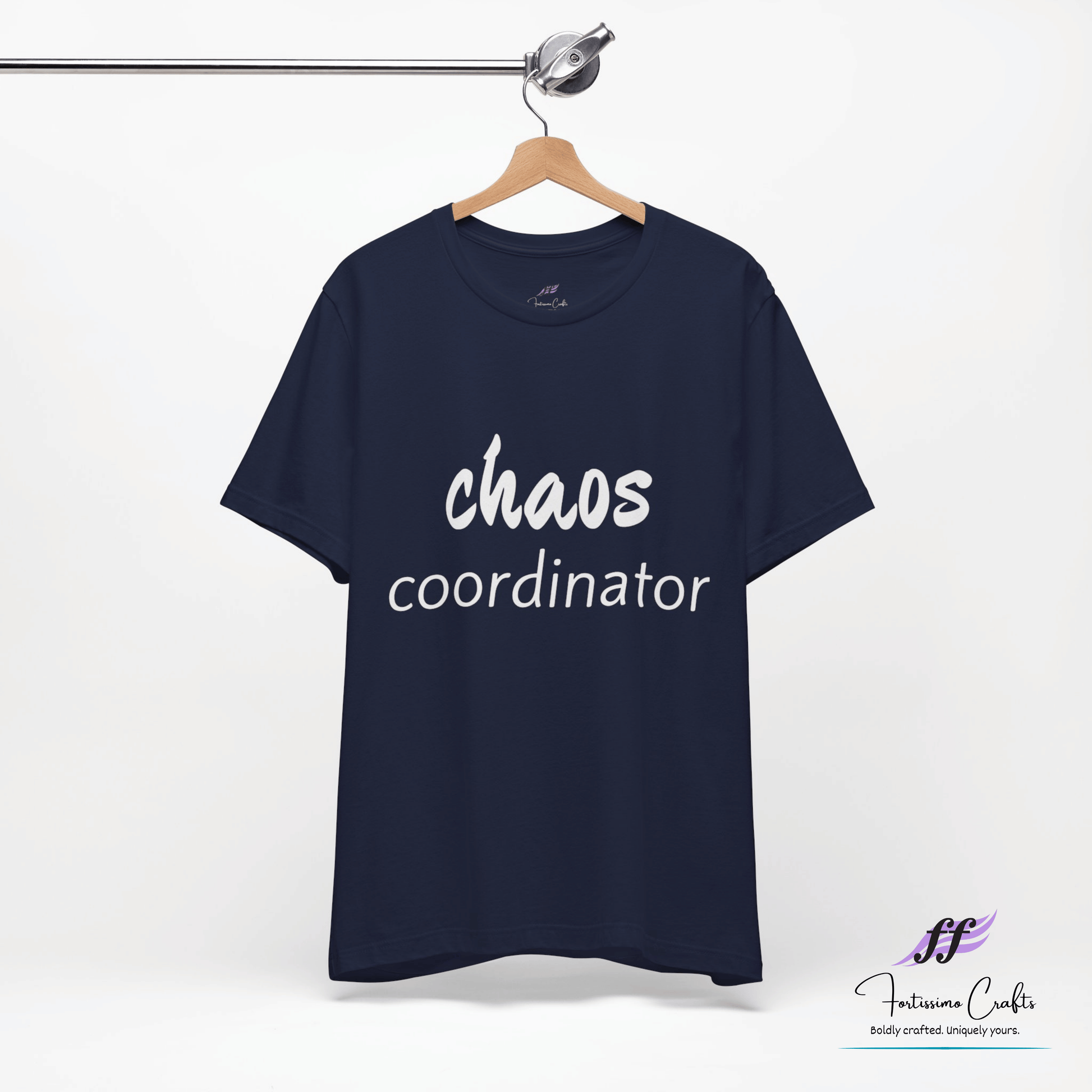 Navy blue t-shirt with 'chaos coordinator' text on a hanger against a white background