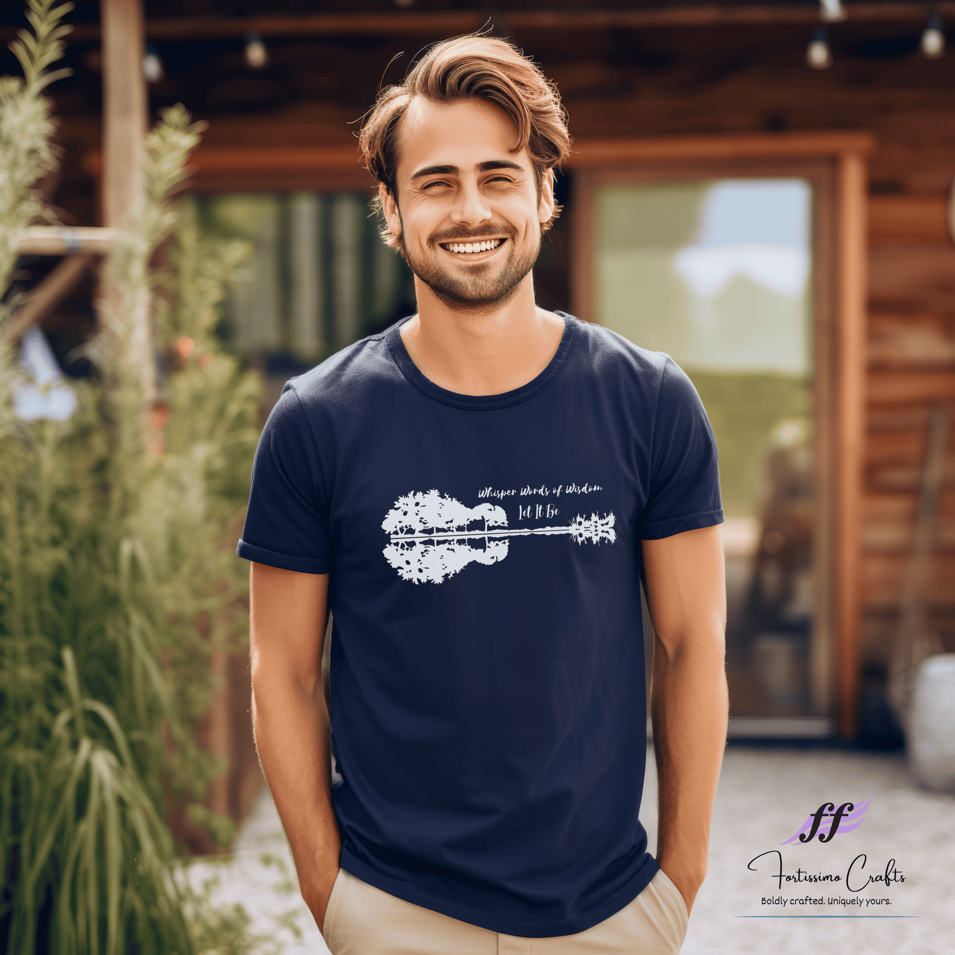 Man wearing a navy blue t-shirt with a graphic design, standing outdoors.