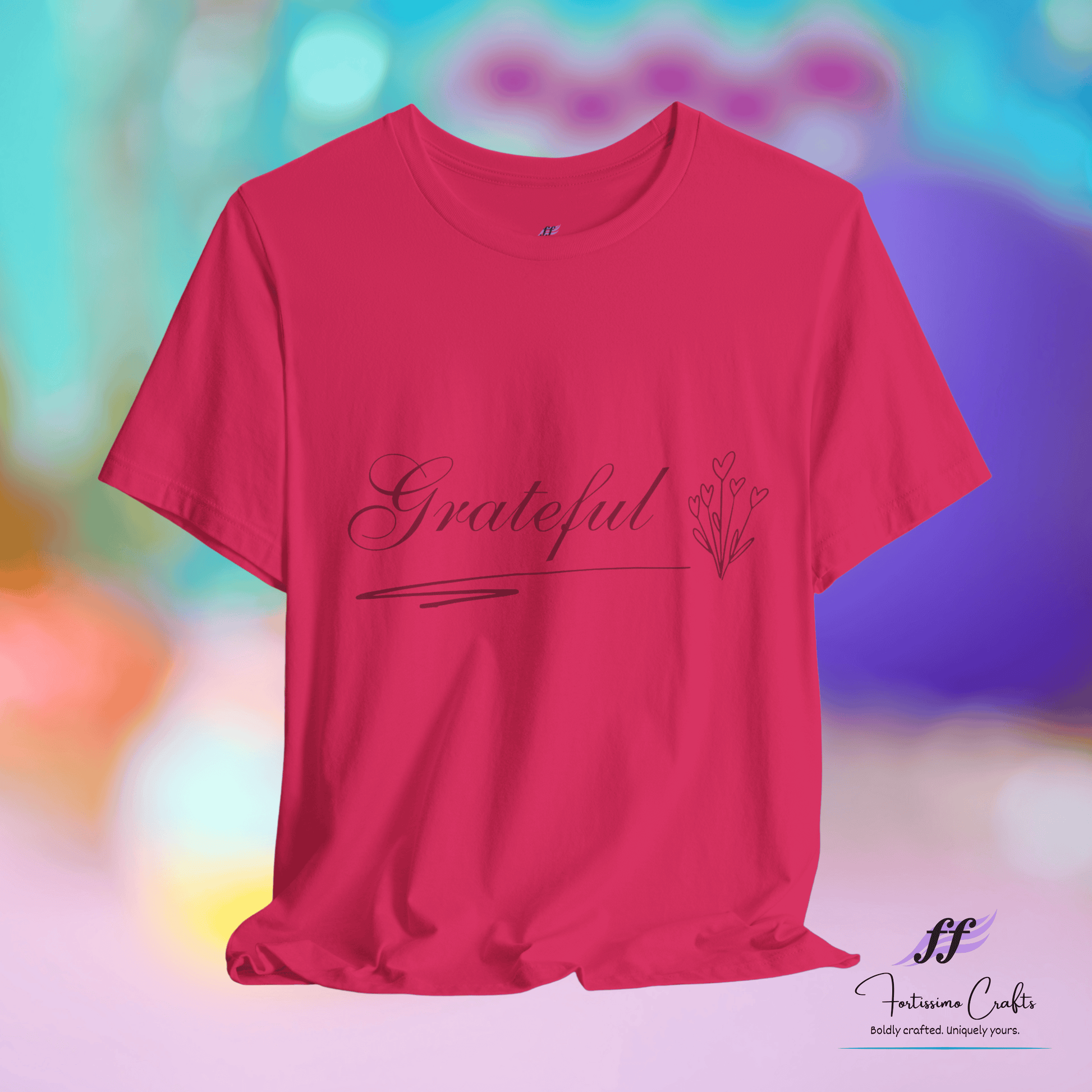 Fuchsia t-shirt with 'Grateful' text on a colorful blurred background