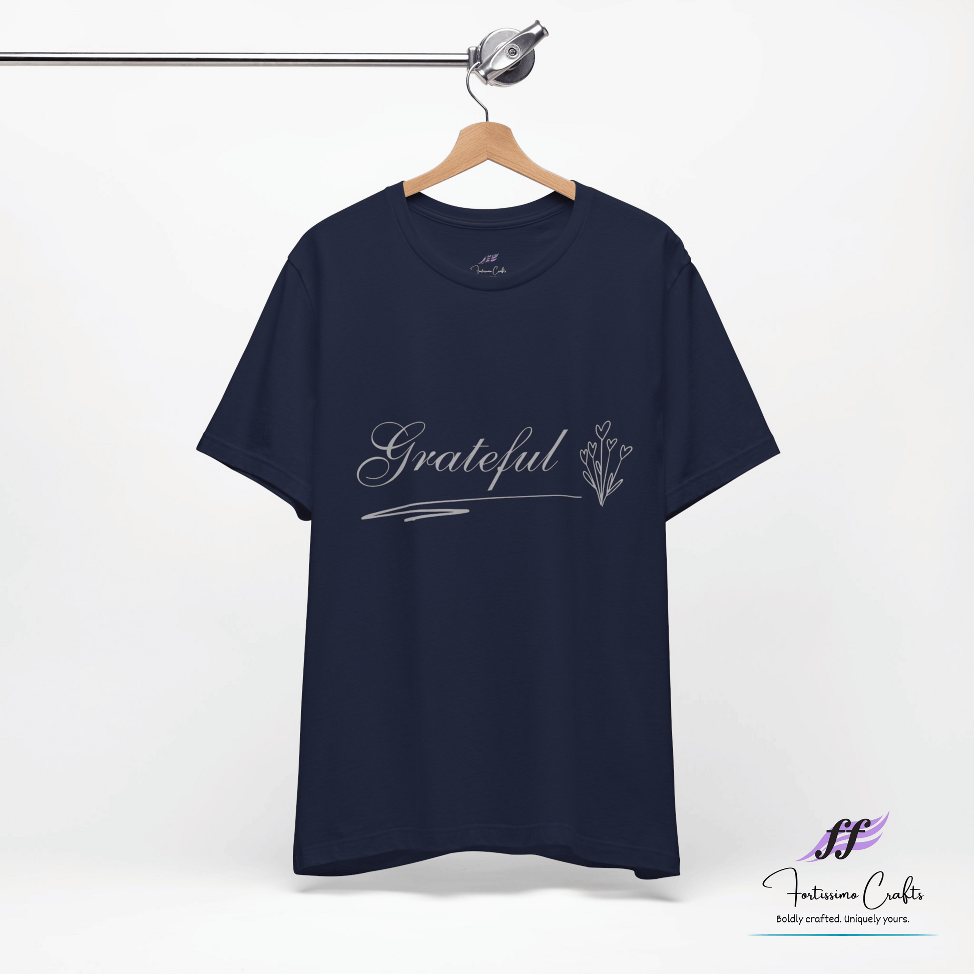 Navy blue t-shirt with 'Grateful' text on a hanger against a white background