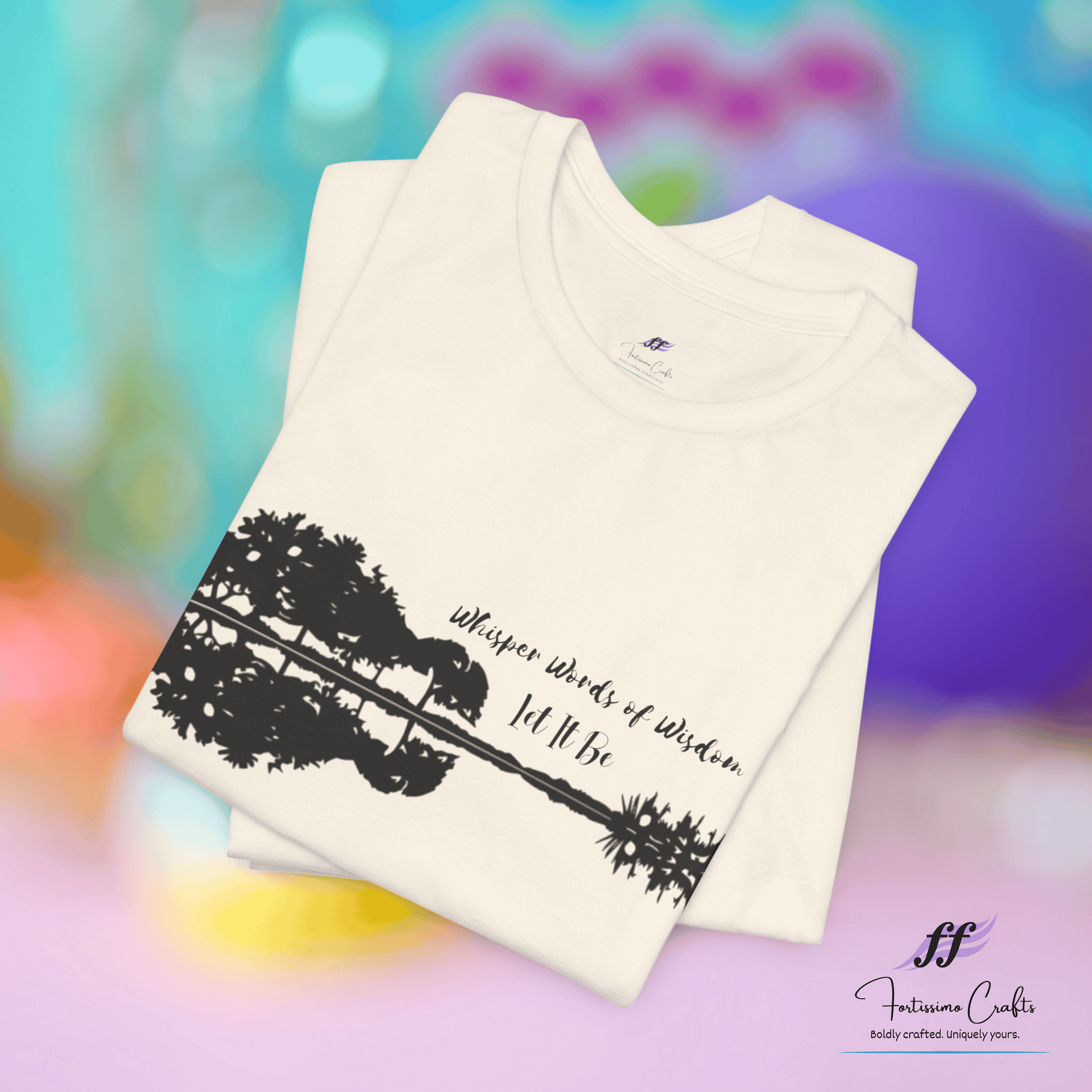 White t-shirt with black graphic design and text on a colorful blurred background
