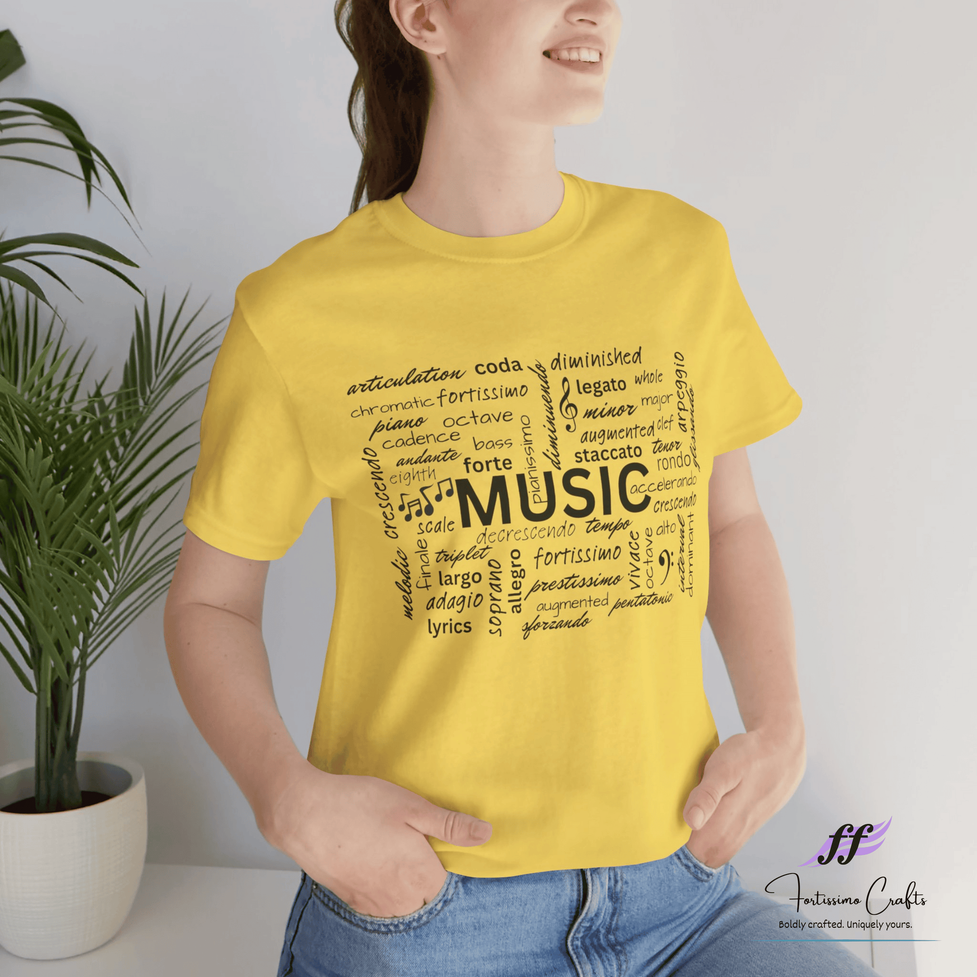 Person wearing a yellow t-shirt with music-themed text, standing next to a plant.