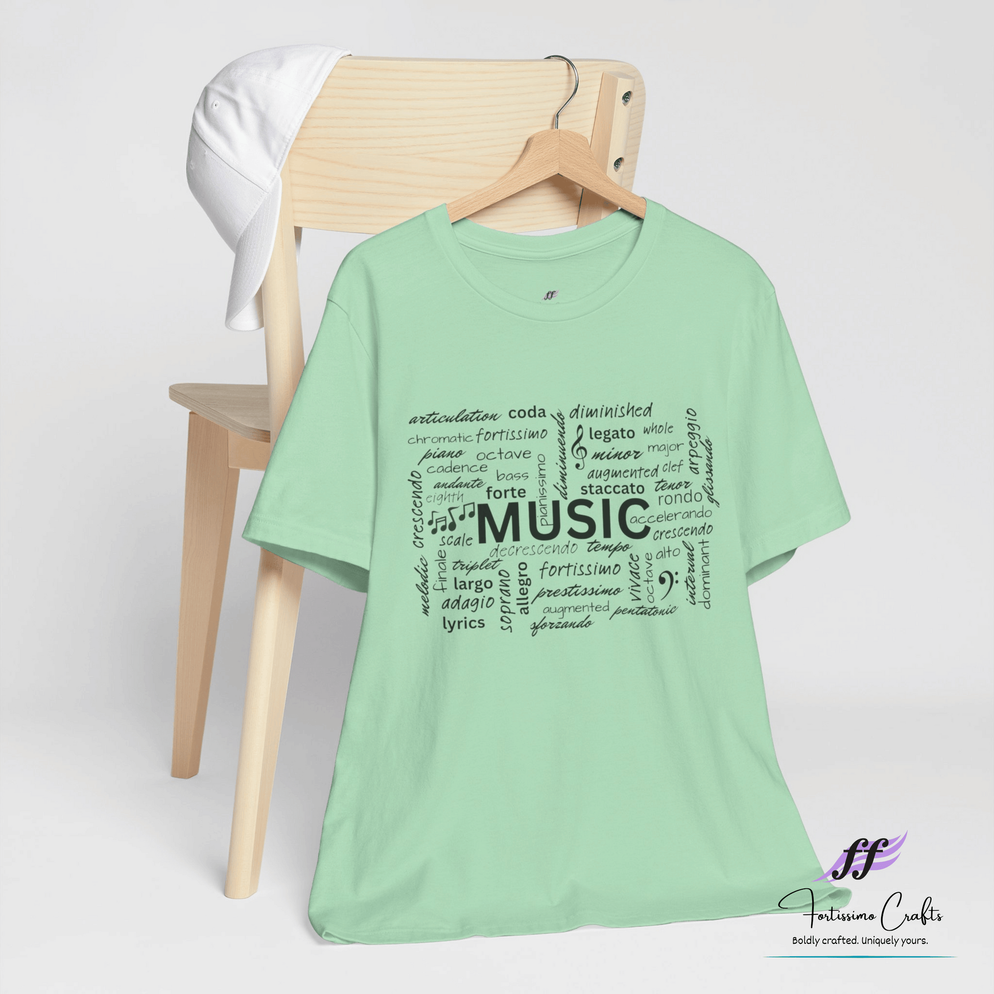 Green t-shirt with music-themed design on a white background