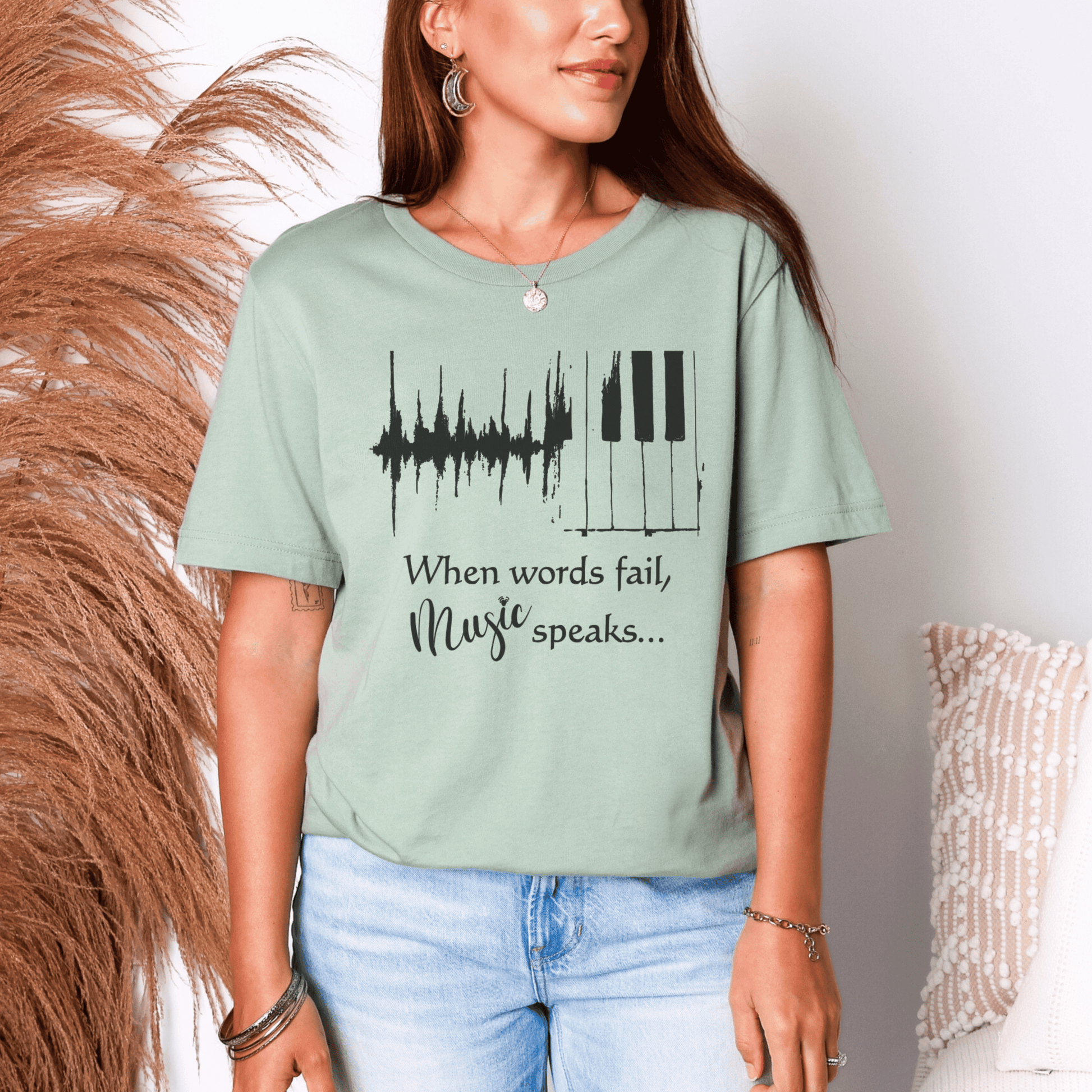 Person wearing a light green t-shirt with a music-themed design and text.