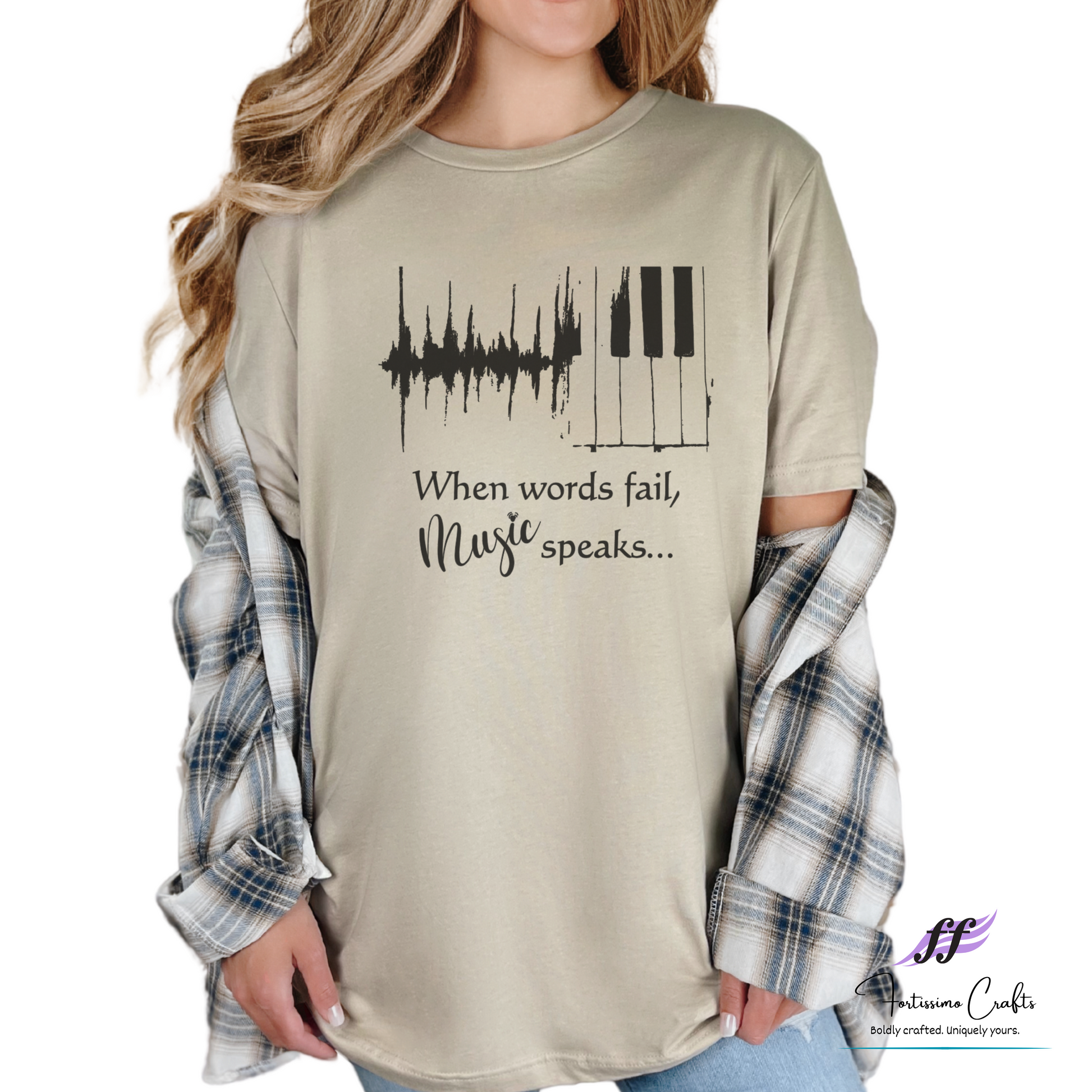 Beige long-sleeve shirt with music-themed design and text, worn by a person.