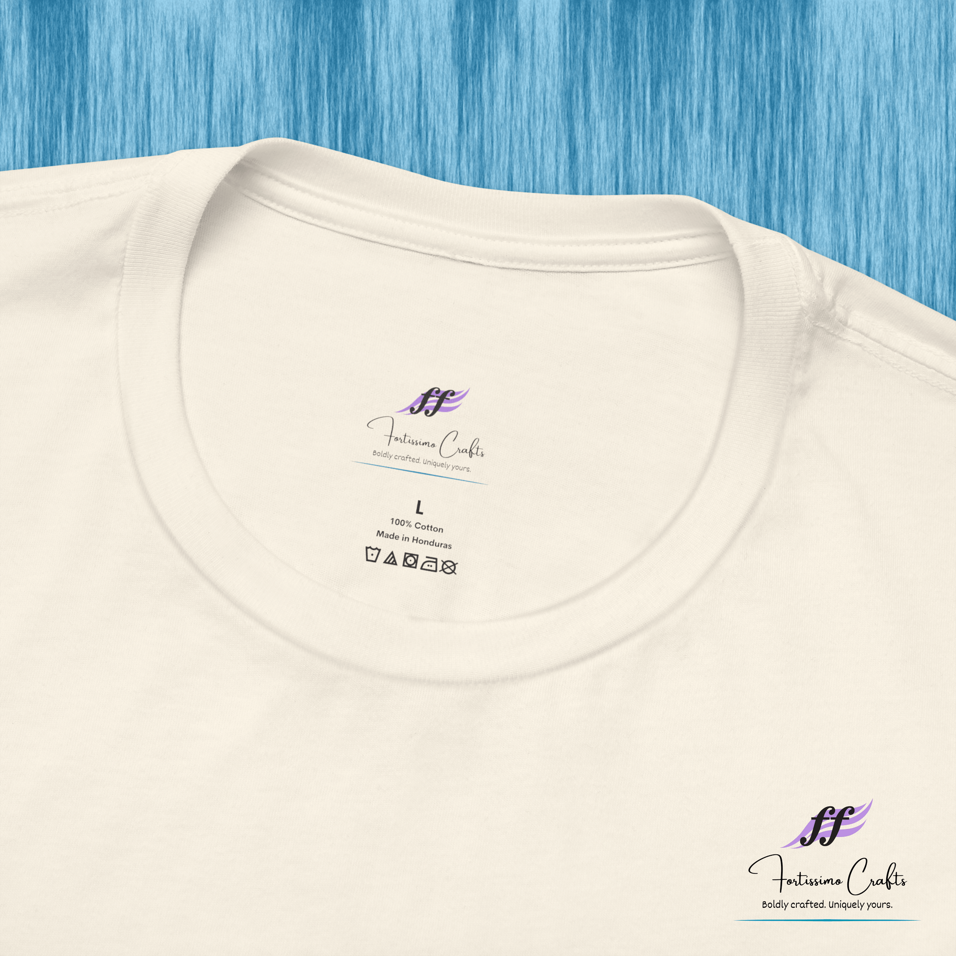 White t-shirt with a brand label on a blue textured background