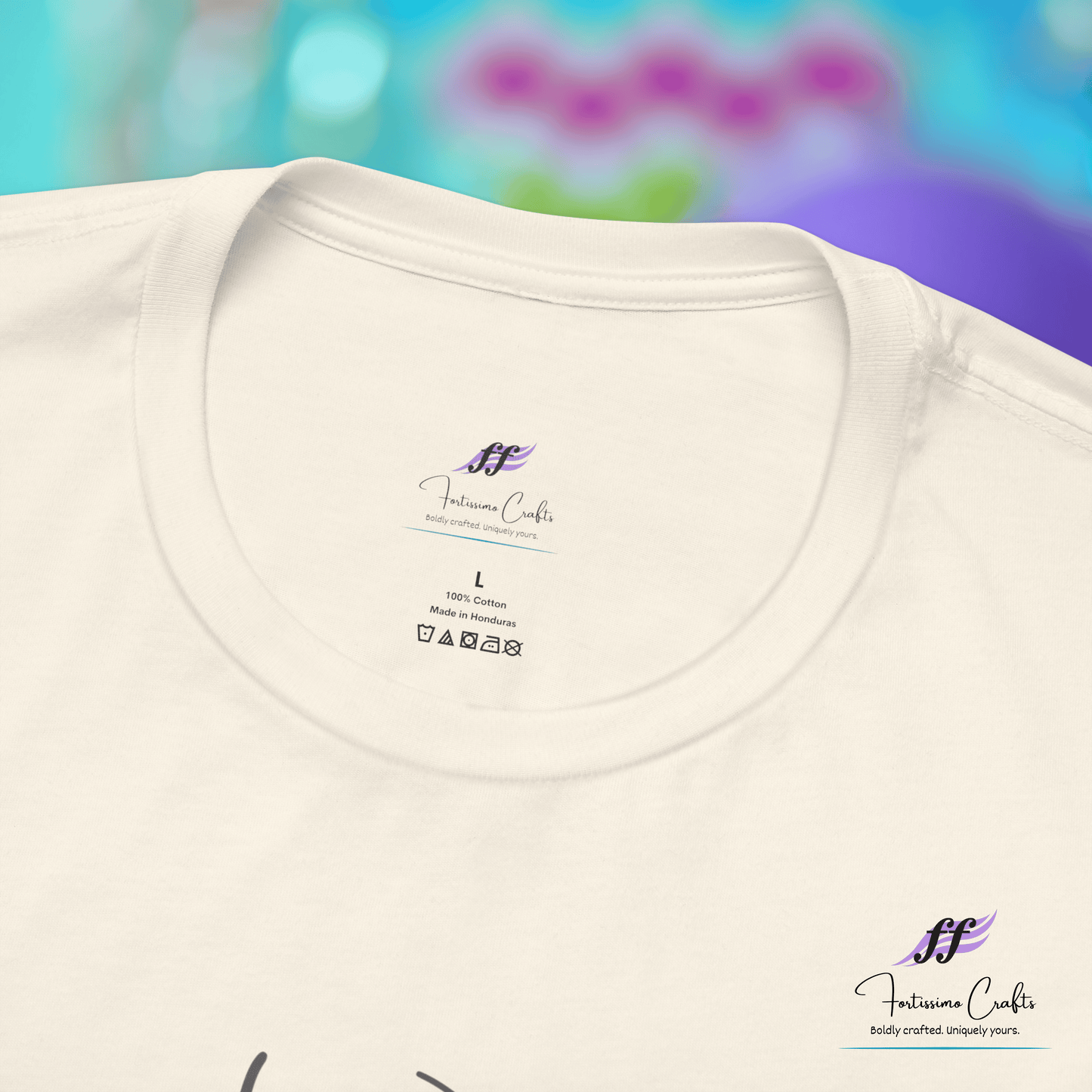 White t-shirt with a brand logo on the collar against a blurred colorful background