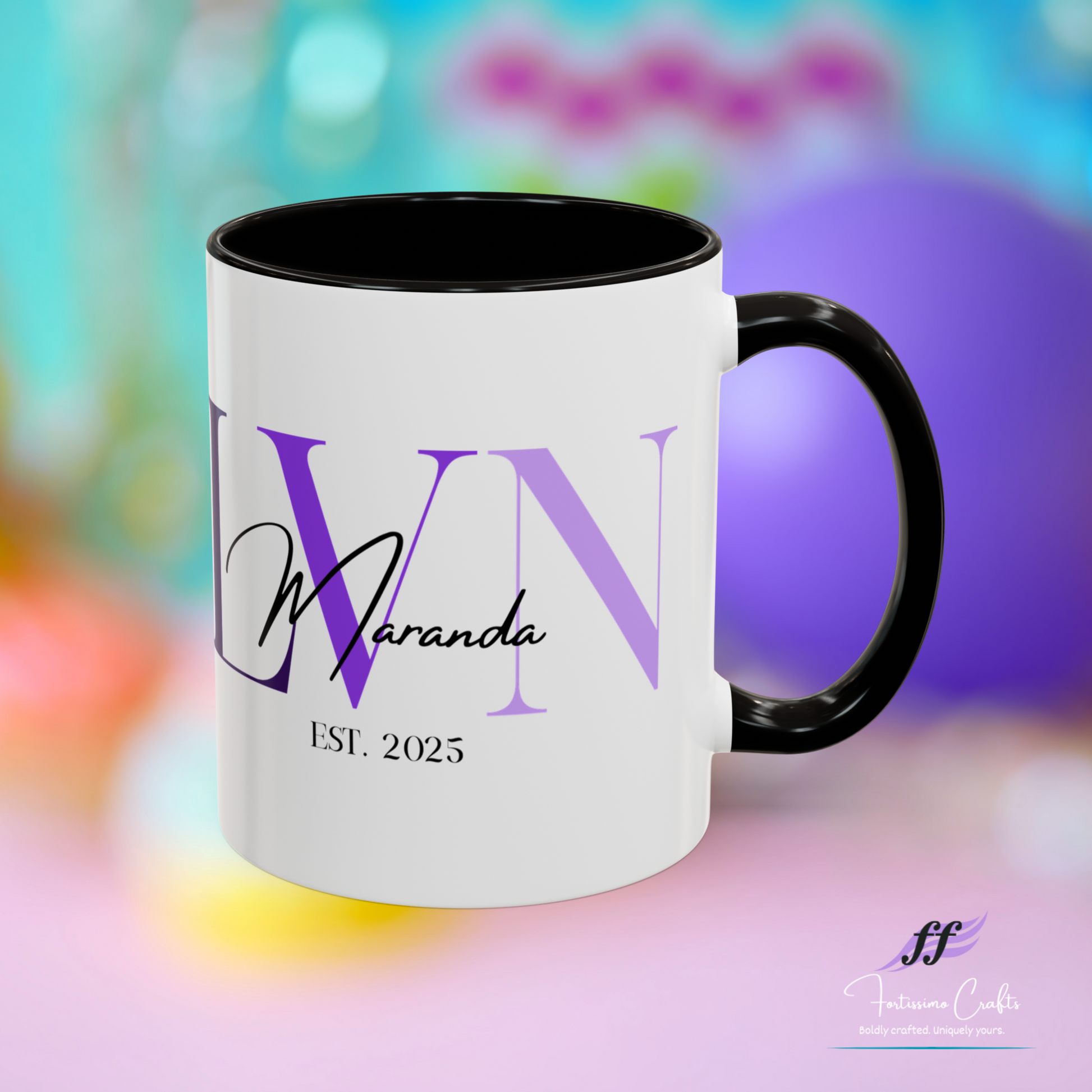 White mug with black interior and handle, featuring 'VN' and 'Maranda' text on a colorful blurred background.