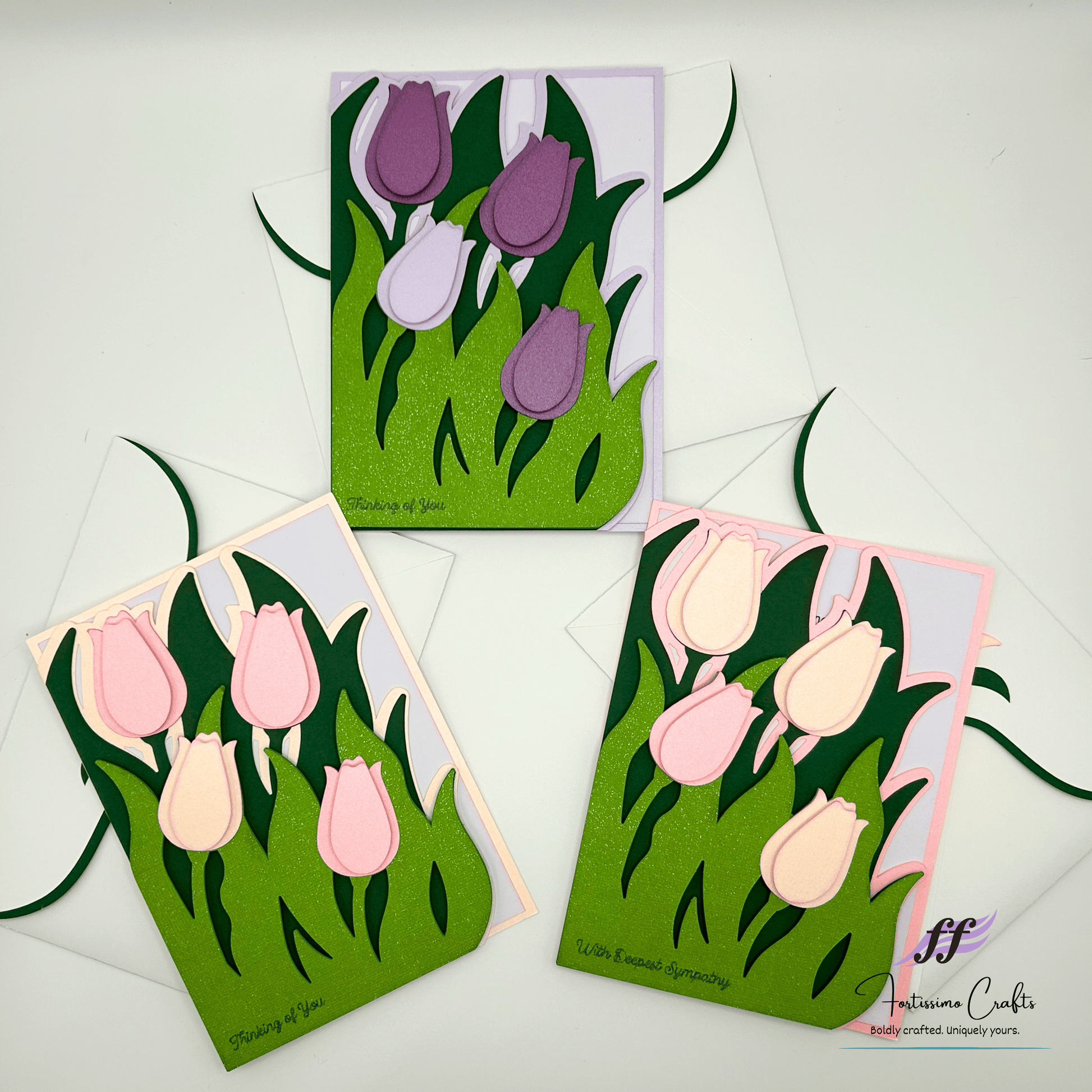 Three greeting cards with tulip designs on a white background