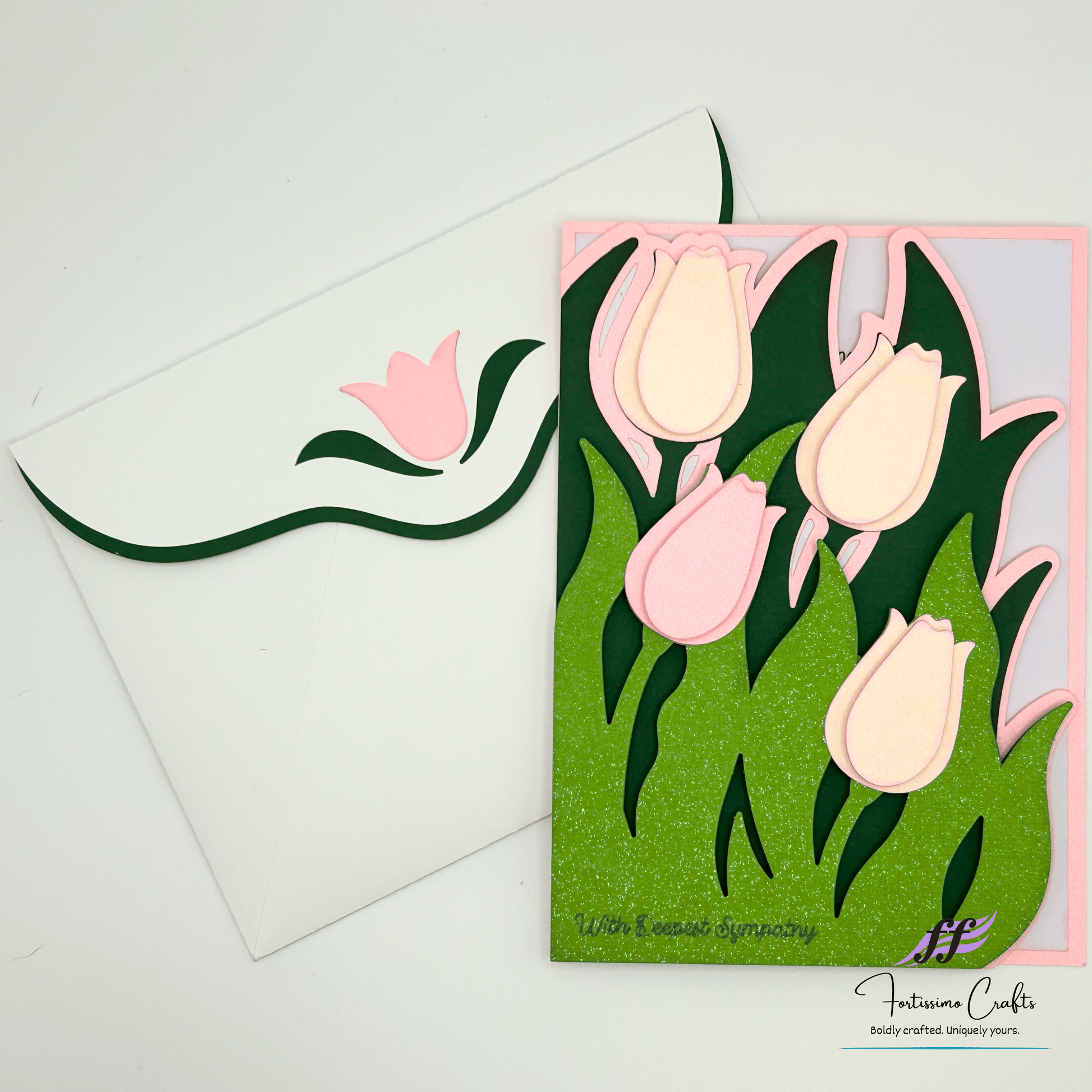 Card with pink and white tulips and a white envelope on a light gray background