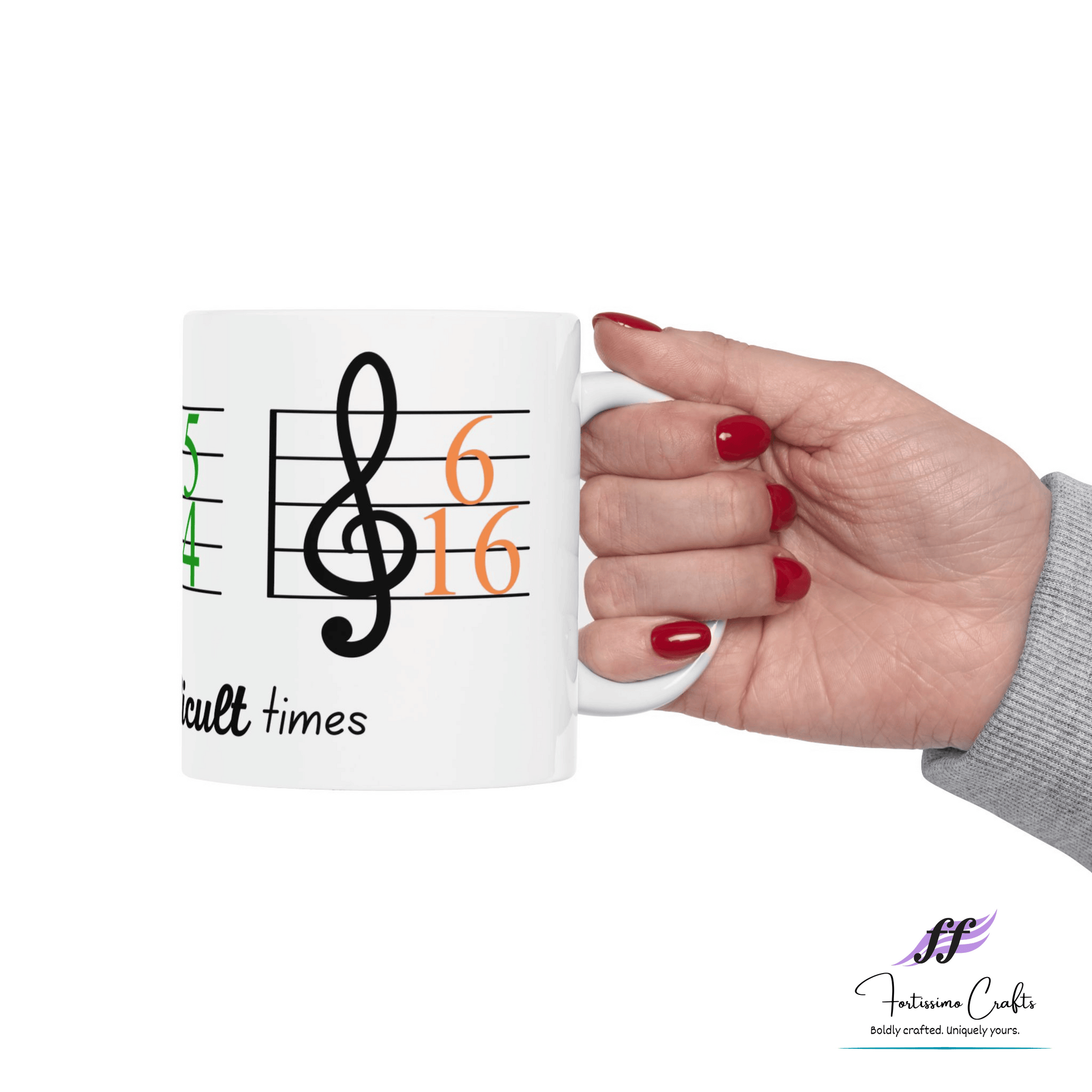 right view of 11oz white ceramic mug with music staff, 6/16 key signature and these are difficult times held in a hand