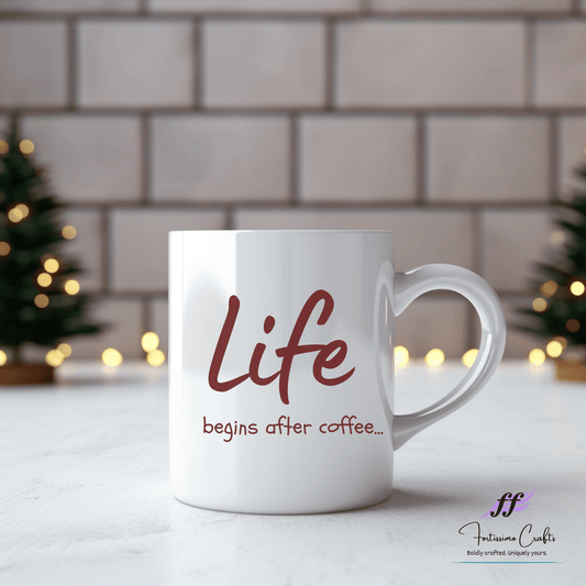 white ceramic mug with "Life begins after coffee..." in brown letters on the front sitting on a table