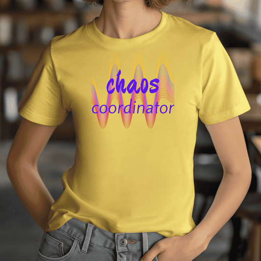 Person wearing a yellow t-shirt with 'chaos coordinator' text and colorful design.