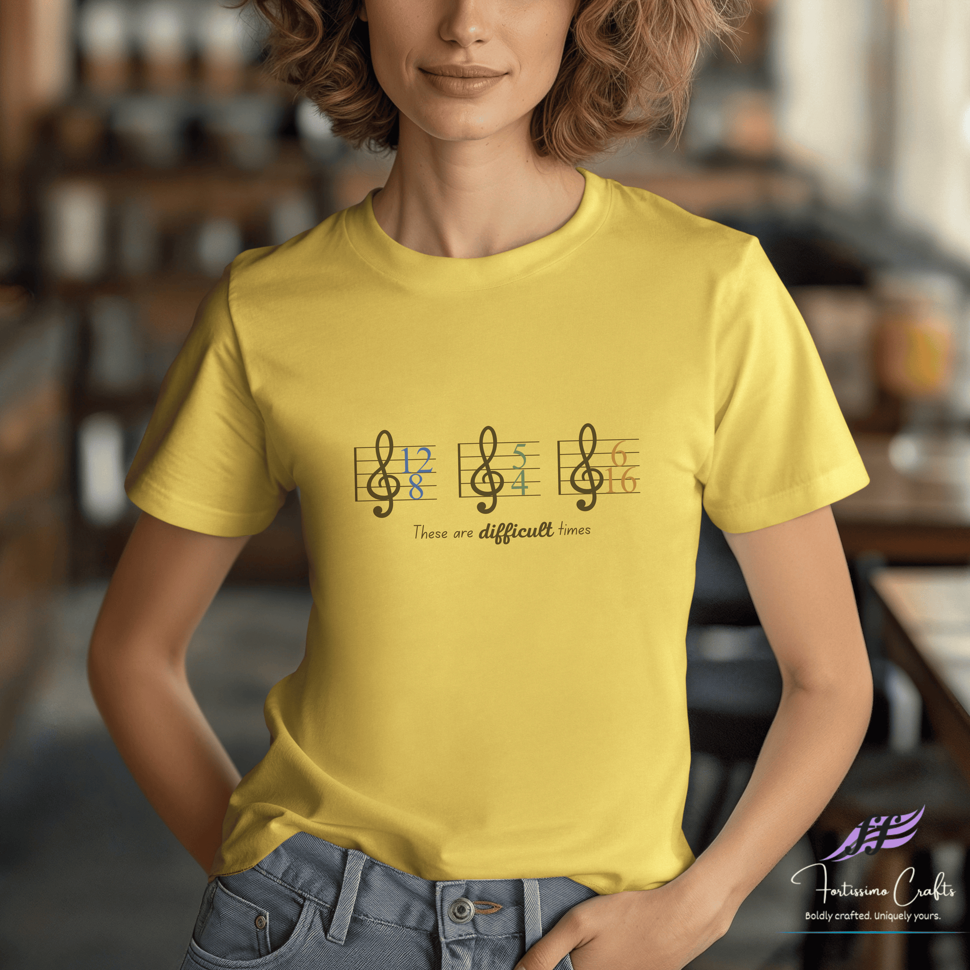 Person wearing a yellow t-shirt with musical notes and text in a casual setting