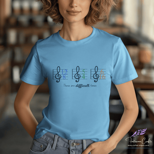 Person wearing a blue t-shirt with musical note design and text in a blurred indoor setting